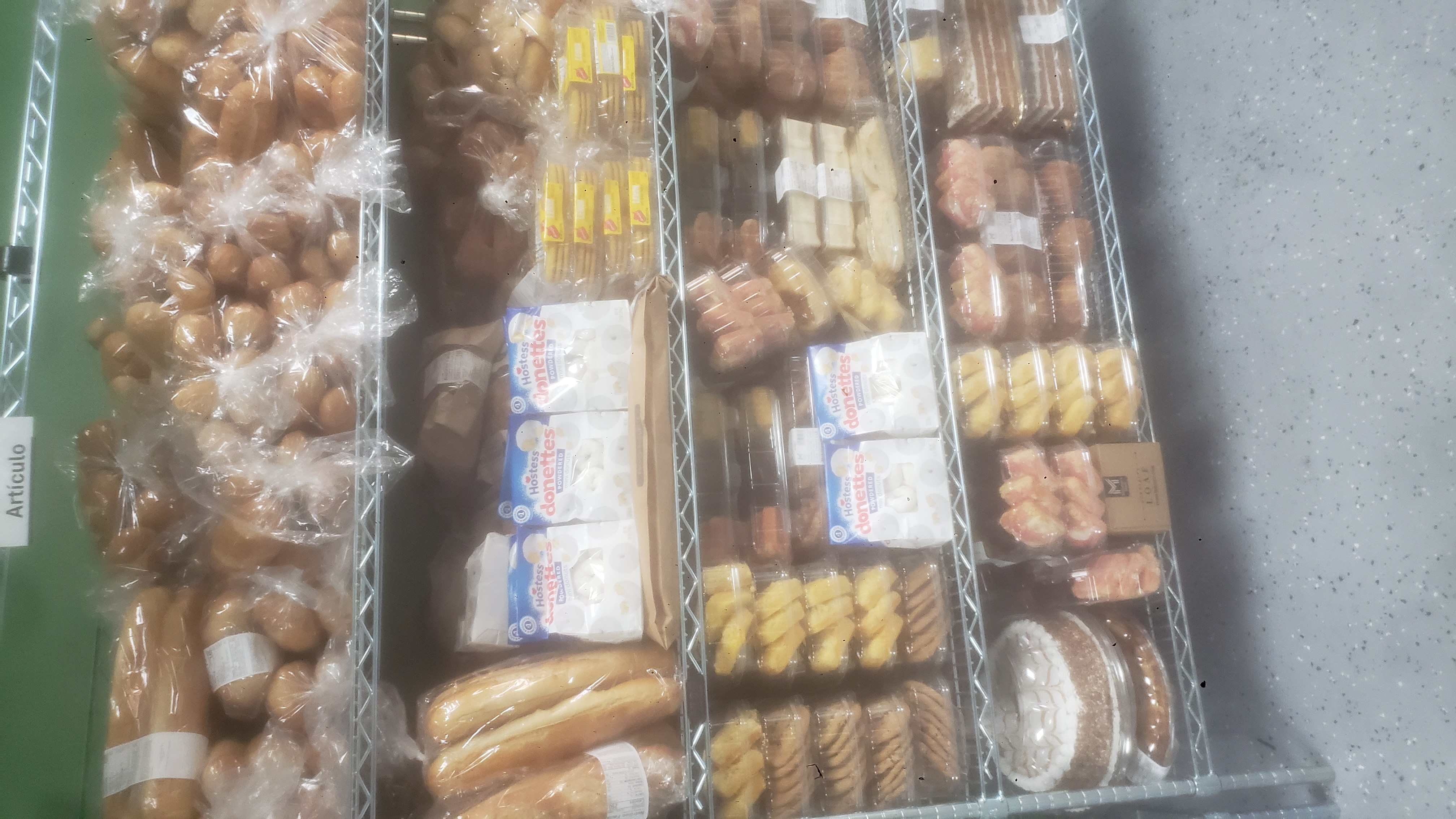 Shelves packed with breads and sweets.